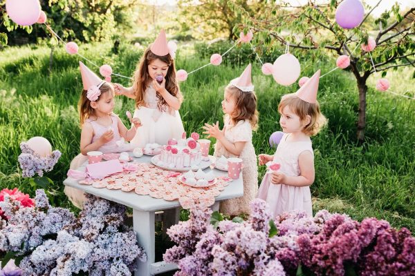 Summer outdoor kids birthday party. Group of happy Children celebrating birthday in park Summer outdoor kids birthday party. Group of happy Children celebrating birthday in park
